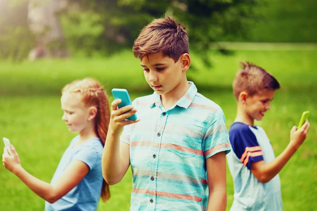 tre bambini con lo smartphone